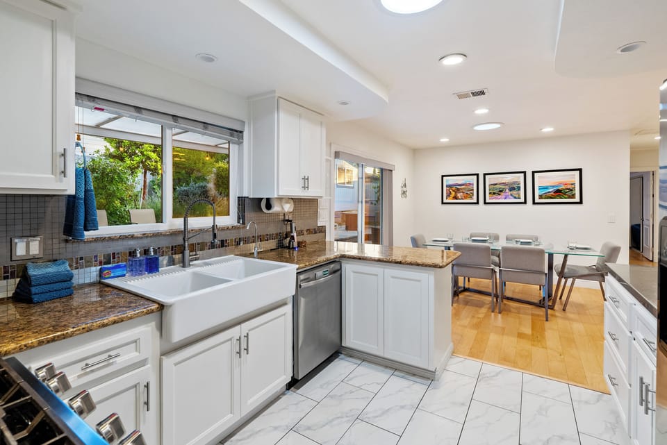 Open kitchen and dining area with daylight and garden views