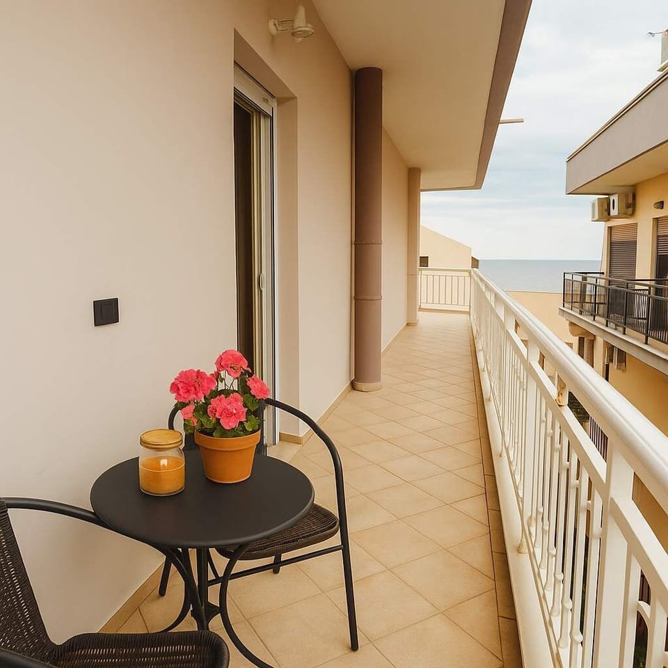A spacious balcony with sea views, perfect for relaxing or enjoying a coffee.
