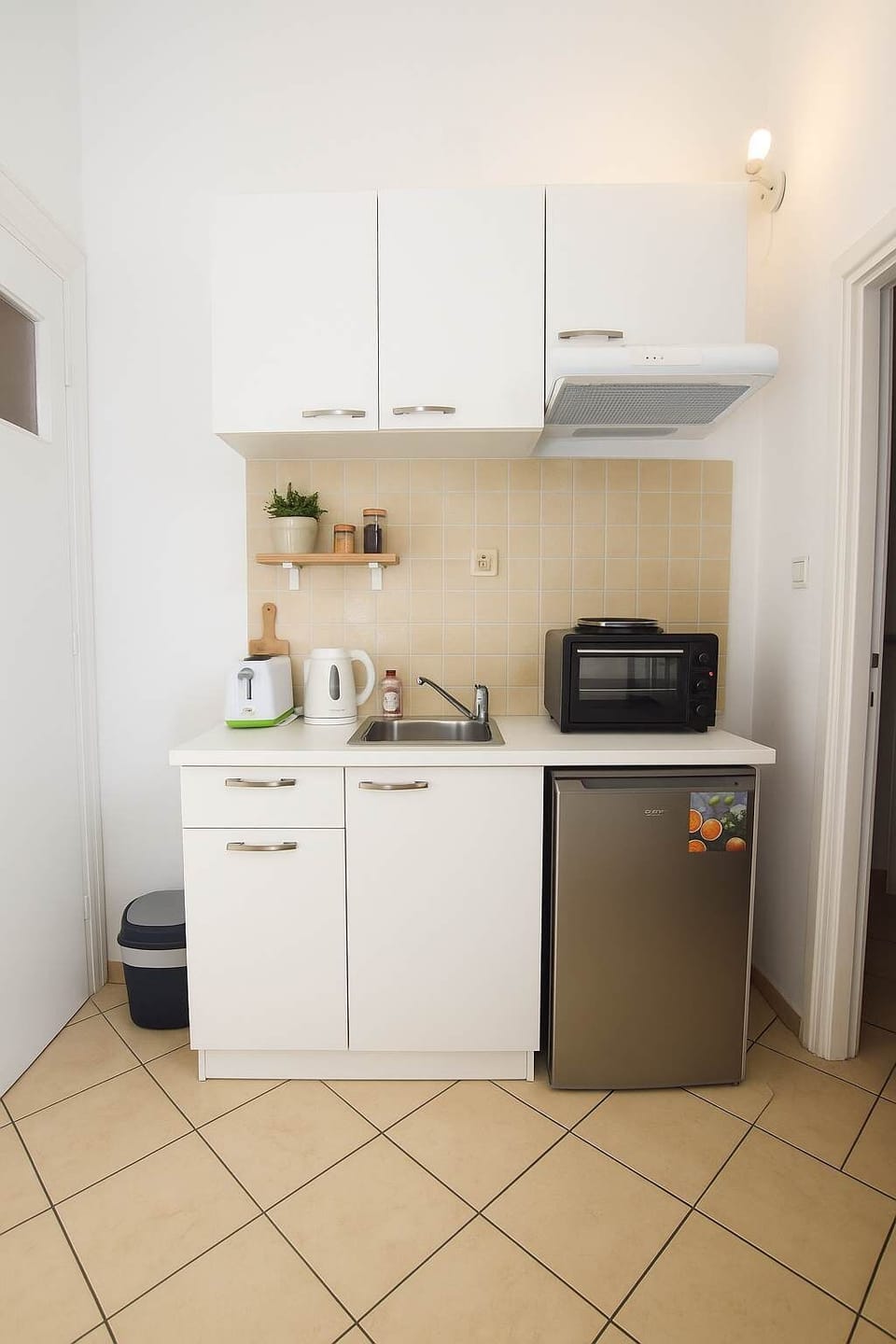 A modern, fully equipped kitchenette perfect for light cooking and quick meals.
