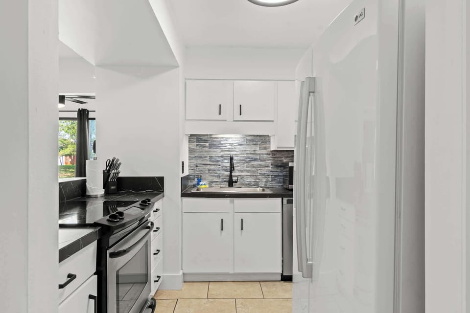 The kitchen is thoughtfully stocked with full-size appliances, dishes, bakeware, pots and pans, silverware, utensils, a crockpot, flat griddle, toaster, blender, and both a traditional coffee maker and a Keurig.