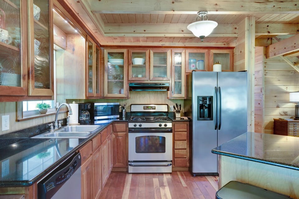 Modern kitchen with stainless steel appliances and a gas stove.