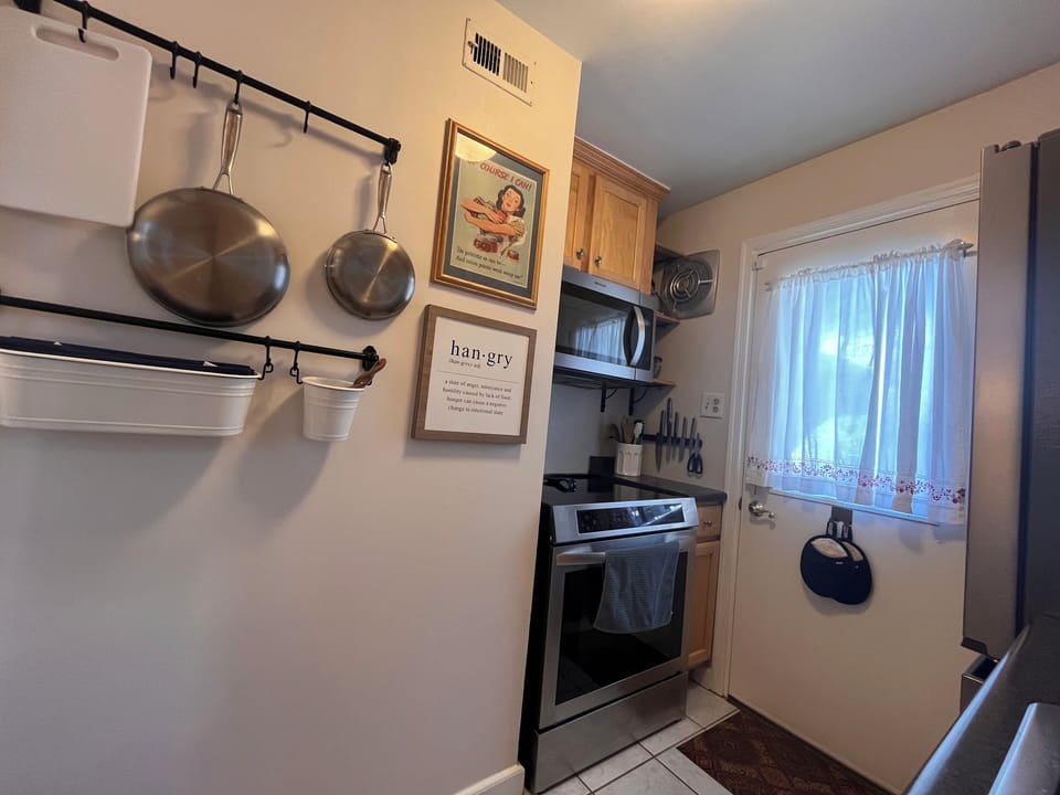 The small-but-mighty kitchen is fully stocked and features all-new appliances.