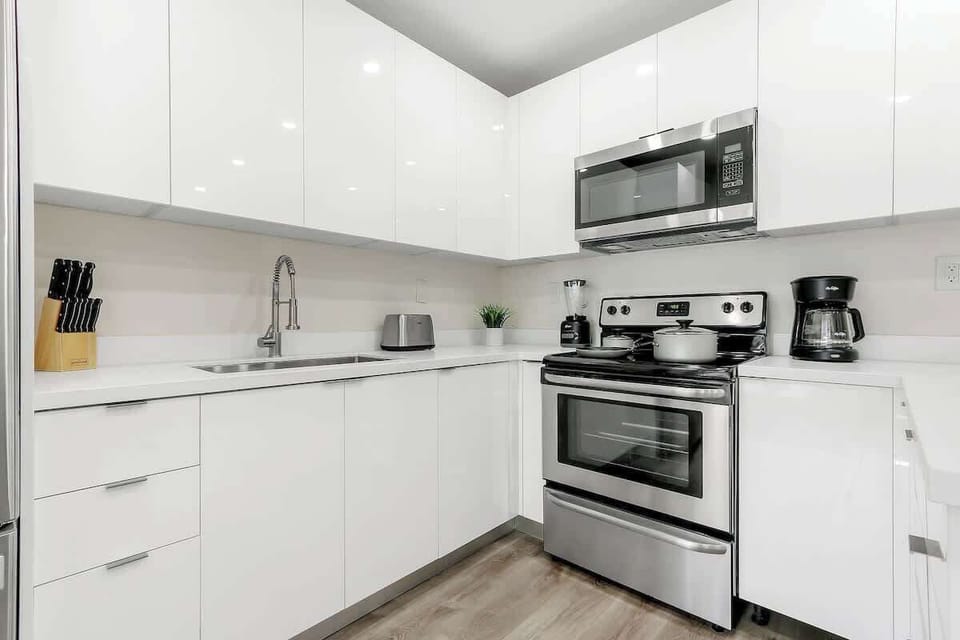 Fully stocked kitchen with complete set of cookware.