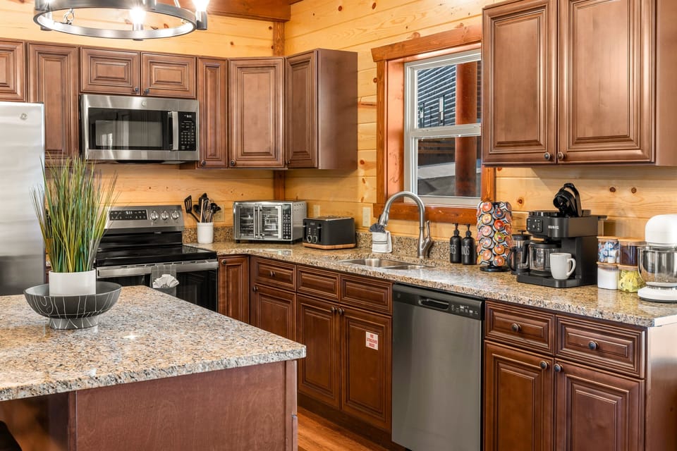 Kitchen with stainless steel appliances and all the essentials for home cooked meals.