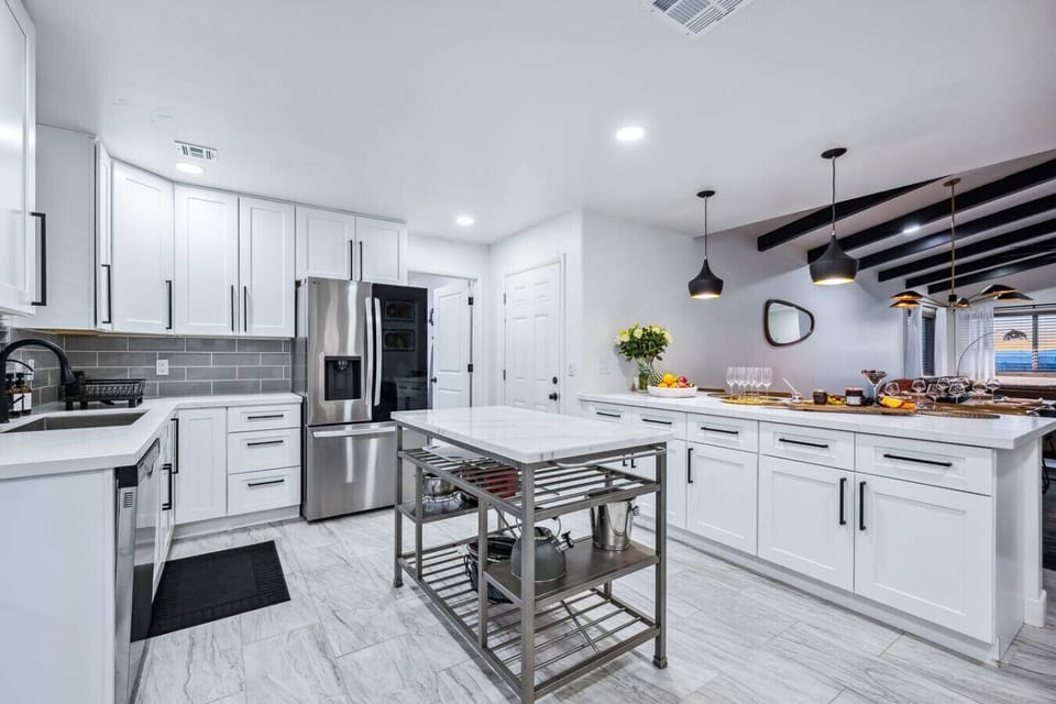 Enjoy a sleek, fully stocked kitchen complete with quality appliances, a center island for prep or serving, and seating for four.