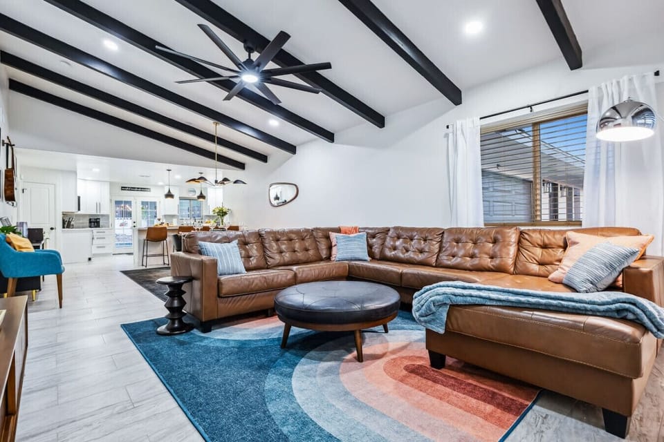 Open-concept living with sleek beams and comfy vibes for the whole group.