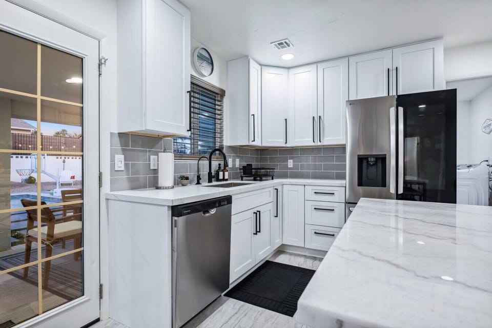 Cook, connect, and unwind in this well-equipped kitchen featuring a large center island and modern appliances.Cook, connect, and unwind in this well-equipped kitchen featuring a large center island and modern appliances.