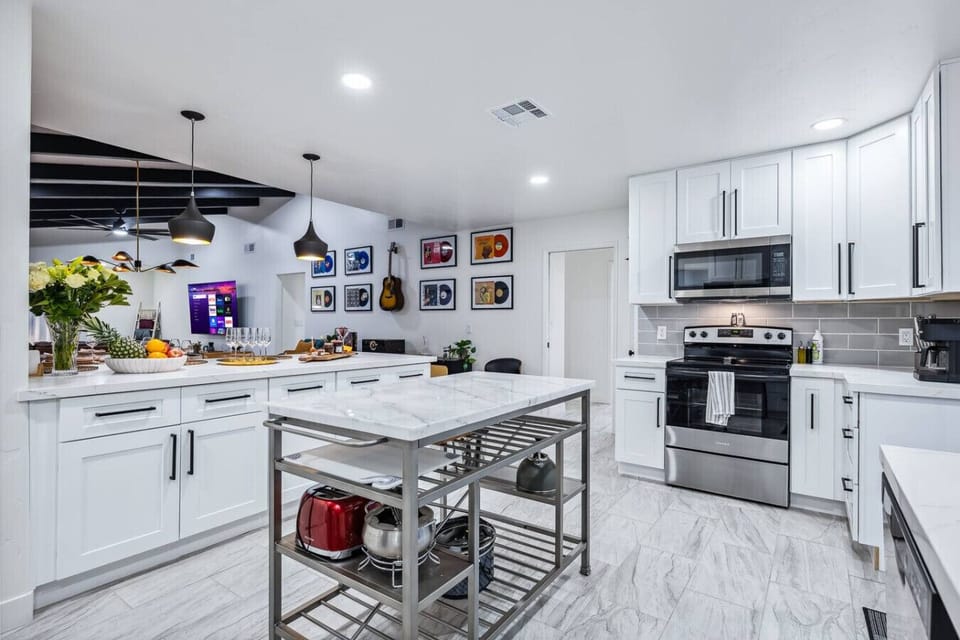 Fully stocked kitchen with modern appliances and a spacious center island.