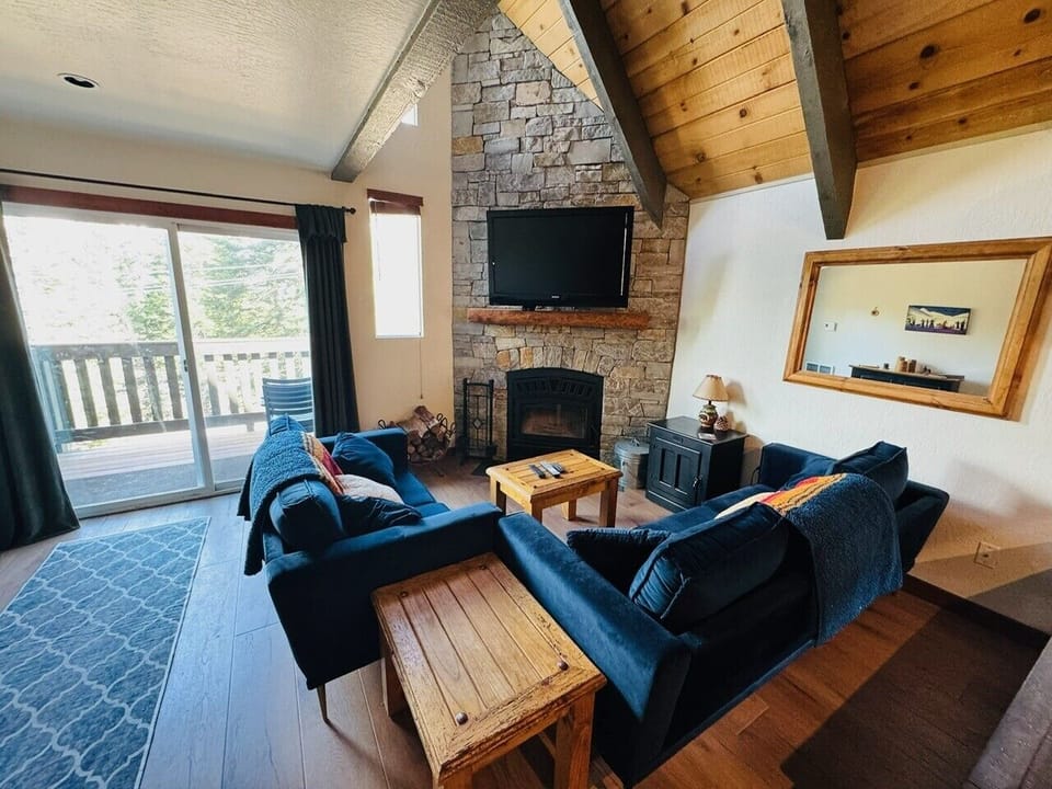 Living area with Vaulted ceilings and wood burning fireplace. 