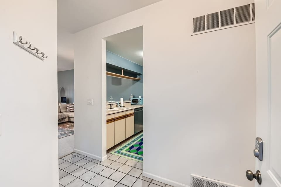 Step inside and immediately enjoy a bright, welcoming view of the kitchen, setting the tone for a warm and functional living space.