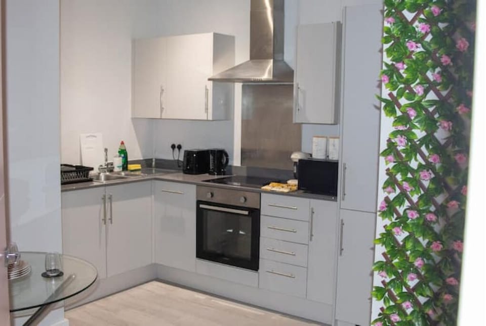 Kitchen with cooker, kettle, toaster, dishwasher, microwave, fridge freezer