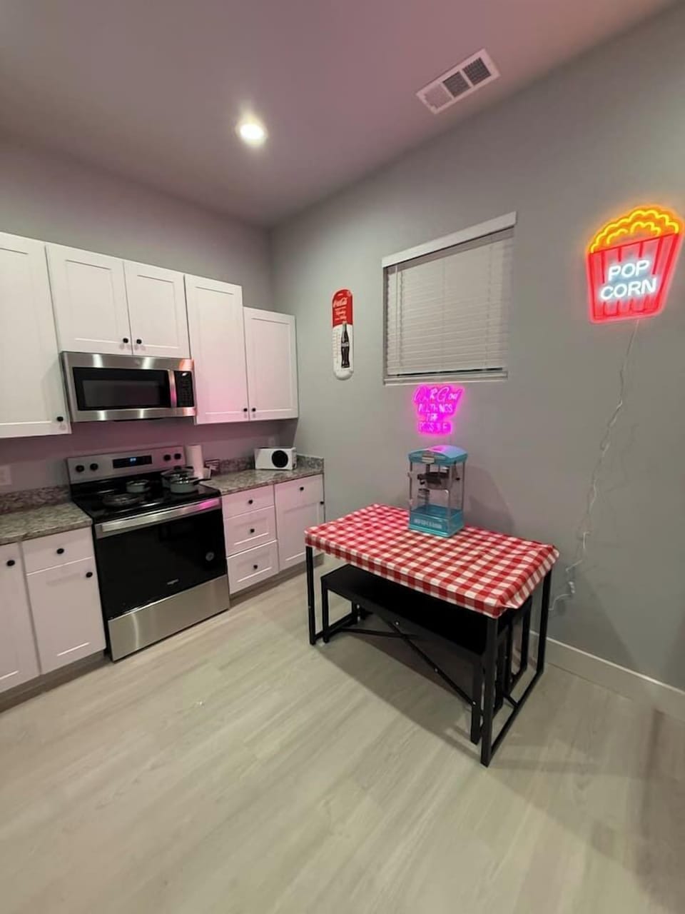 4 seater small dining table. More open seating in living room area.