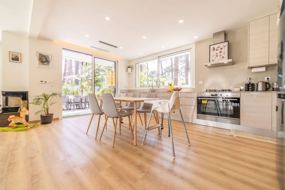 Bright open-plan kitchen and dining area with wooden furniture — Villa Aroeira Village, holiday villa in Aroeira