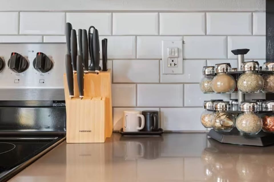 Knife set, toaster, and spice rack in modern kitchen with subway tile backsplash