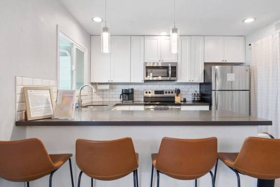 Sleek modern kitchen with stainless steel appliances and white cabinetry