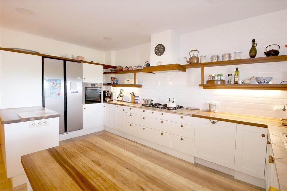 Open kitchen is fully equipped with all the appliances