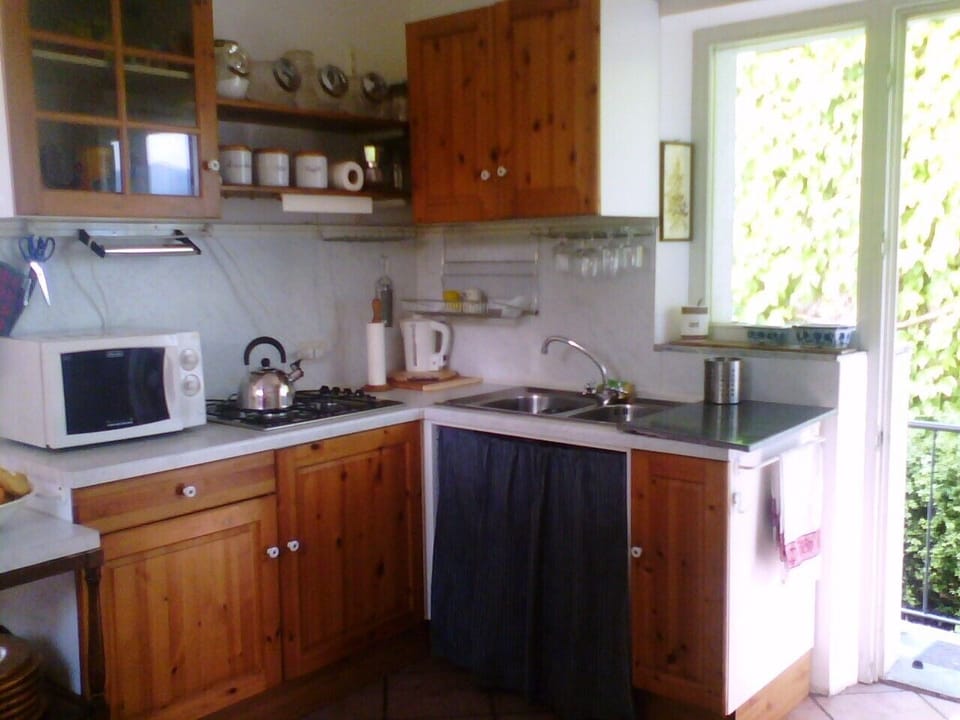 Kitchen with door leading to balcony and stairs to garden