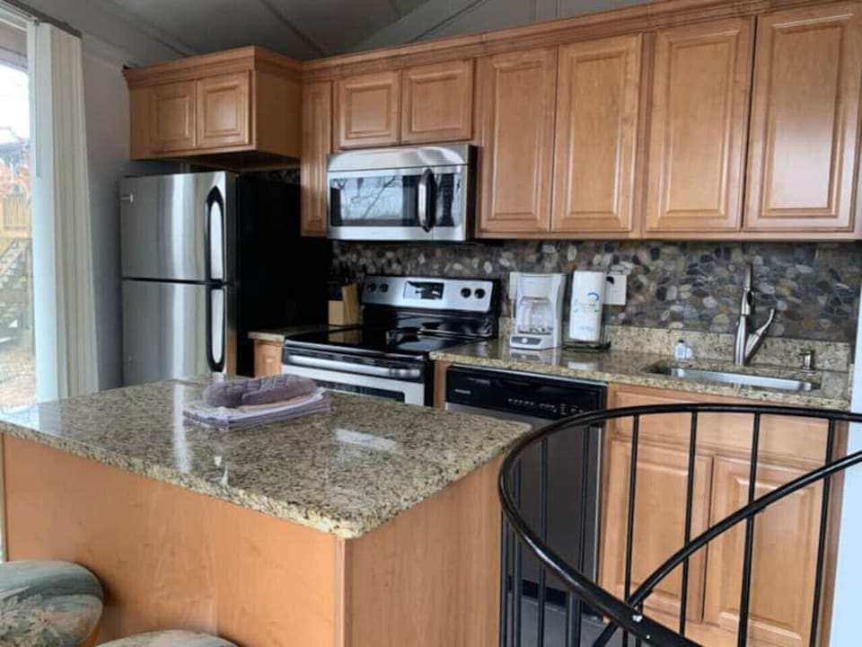 Prepare meals with ease in the well equipped kitchen, featuring all the essentials for your stay at Treetop Village.