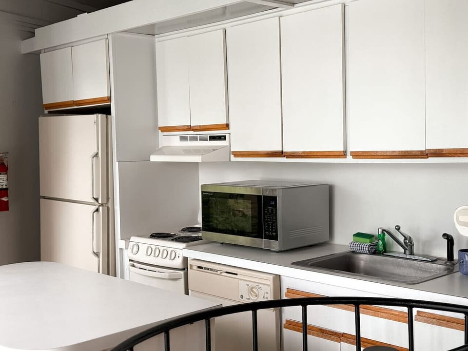 The bright and open kitchen with a convenient island, seamlessly connected to the dining area and offering picturesque views.