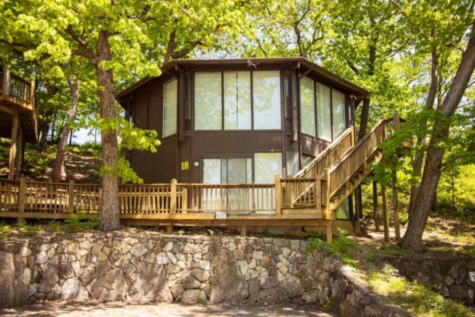 This modern elevated home offers a unique `treetop` living experience, blending seamlessly with the surrounding lush natural landscape. Multiple large windows allow for abundant natural light and scenic views, making this a bright and inviting retreat.