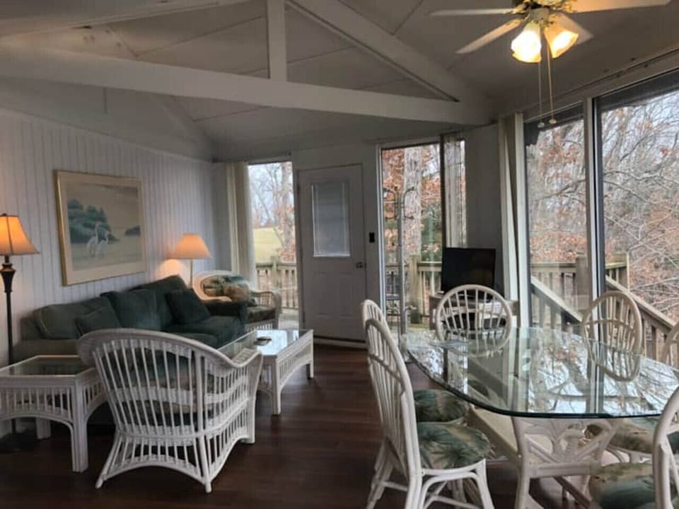 The bright and open living and dining space of Treetop Village , offering a welcoming atmosphere for up to 8 guests.