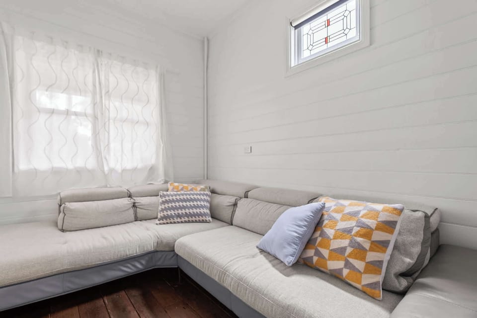 The lounge area features a comfortable sofa, creating a relaxed and welcoming space for everyday living or entertaining.