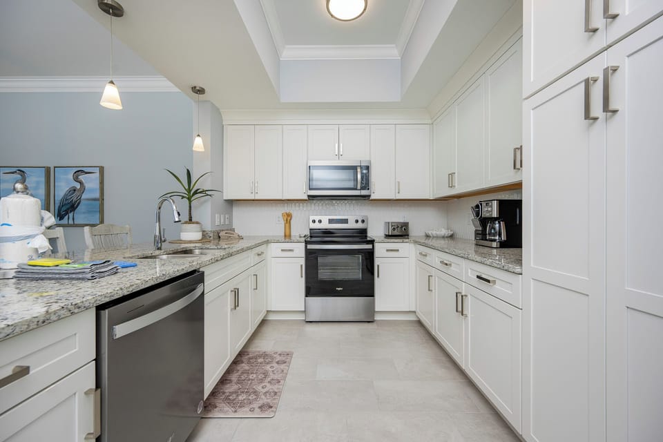 Prepare meals in the stylish kitchen featuring granite countertops, stainless appliances, and sleek cabinetry