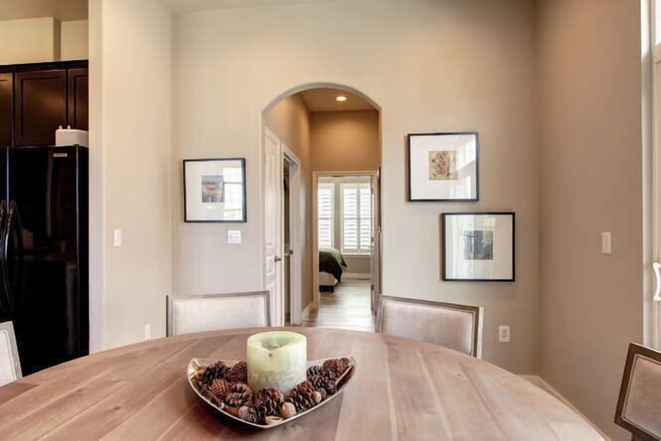Dining table with view of the hallway leading to the bedroom 