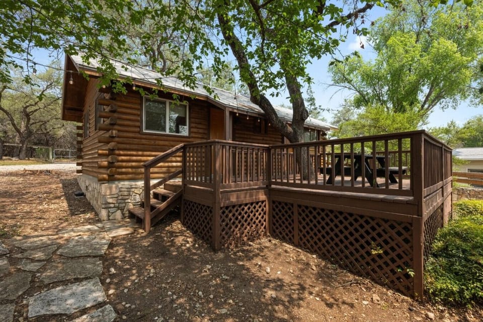 This spacious shared deck offers peaceful shade, a picnic table for outdoor meals, and a relaxing space to unwind after a day on the lake.