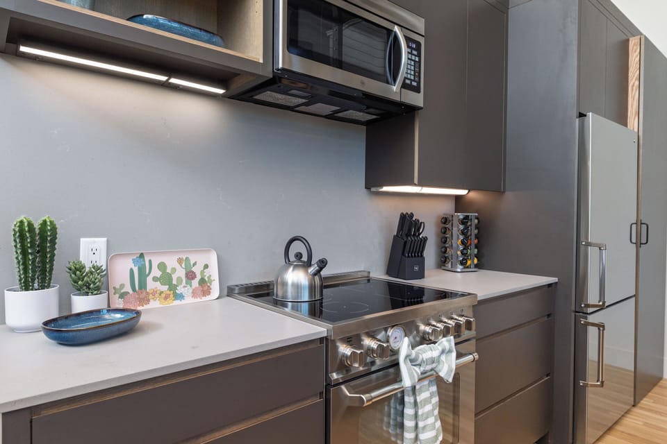Kitchen is fully stocked and ready to use, with seating for 4 at the island.