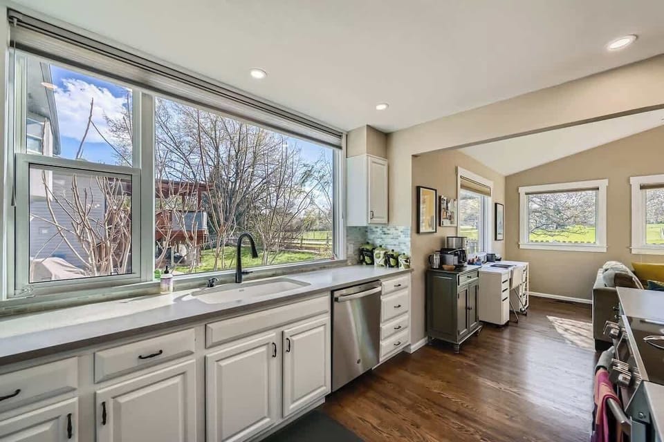 Spacious kitchen with everything needed for comfortable meal preparation and a big window for sunlight to shine through 