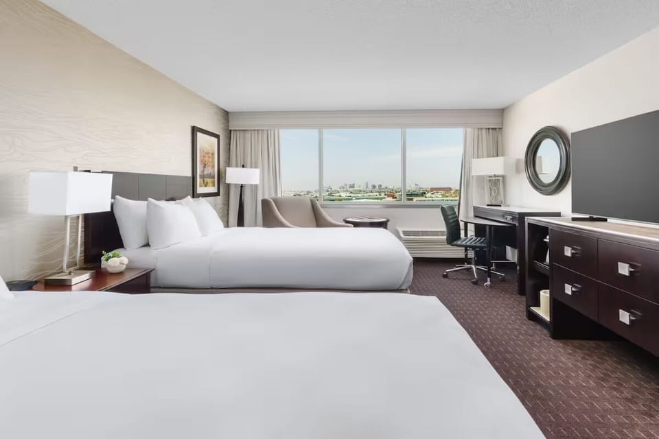 Wake up to bright city views from crisp, cloud-soft beds.
