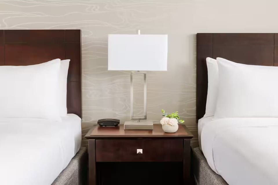 Drift off between two cozy beds with warm bedside lighting.