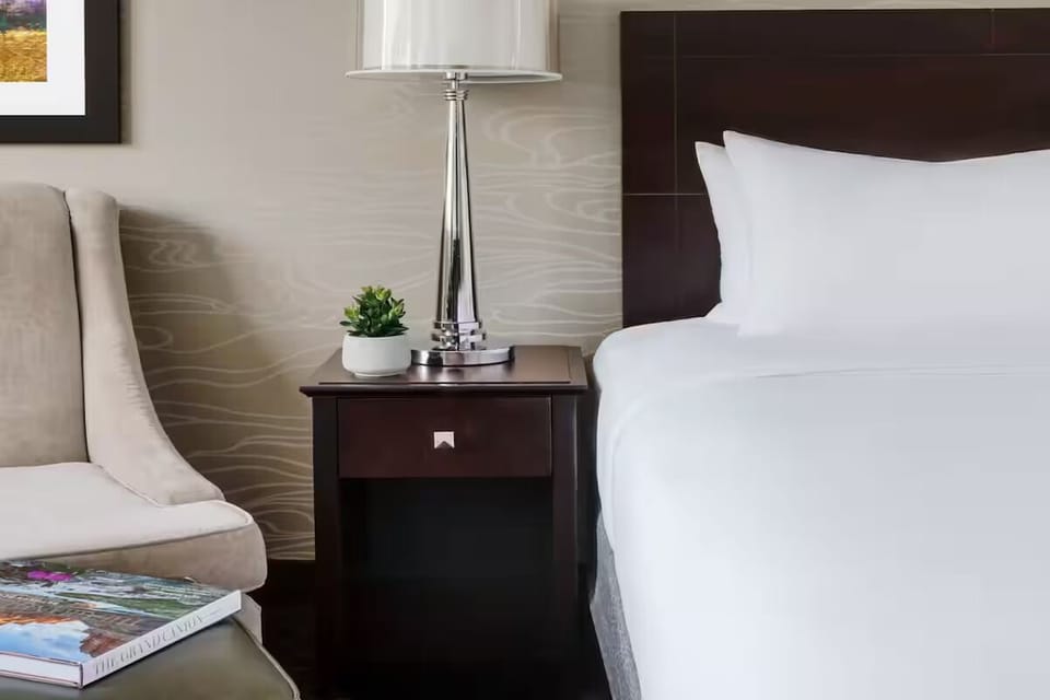 Unwind beside crisp linens and a softly lit nightstand.