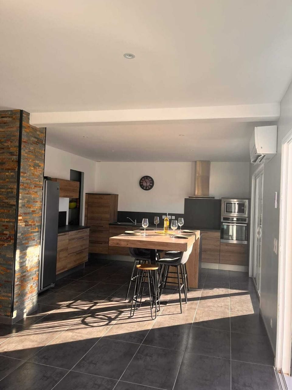Large air-conditioned living room opening onto the kitchen