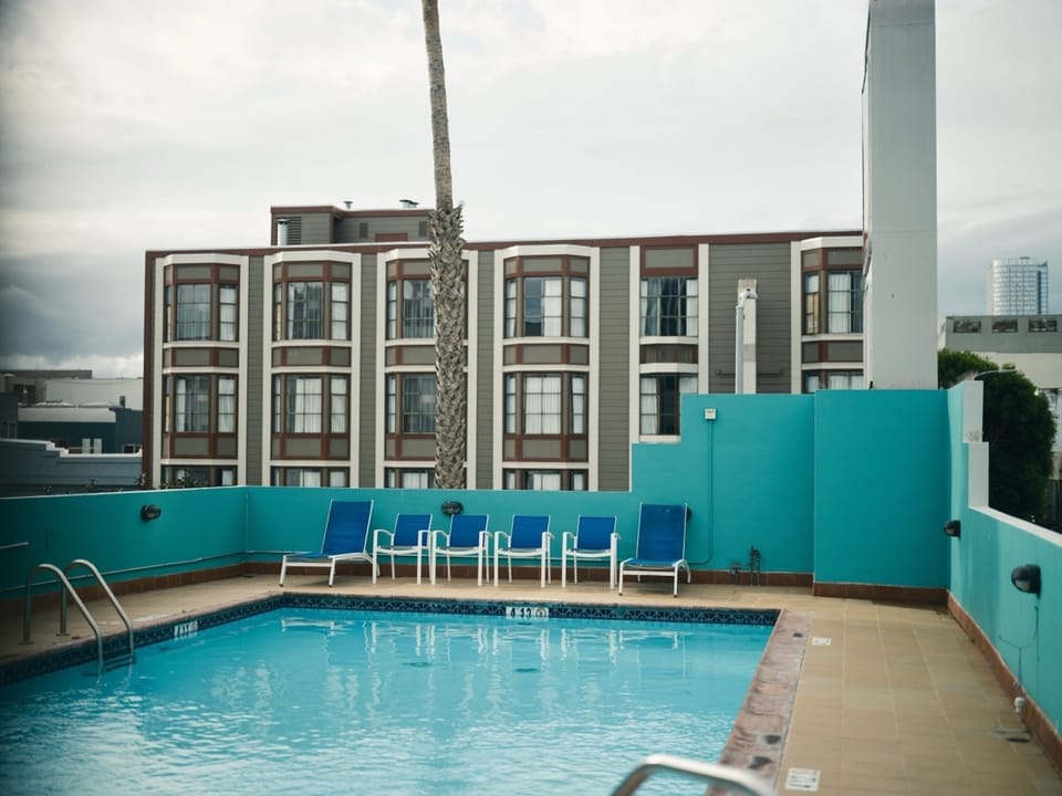Unwind poolside with a calm swim under open skies.