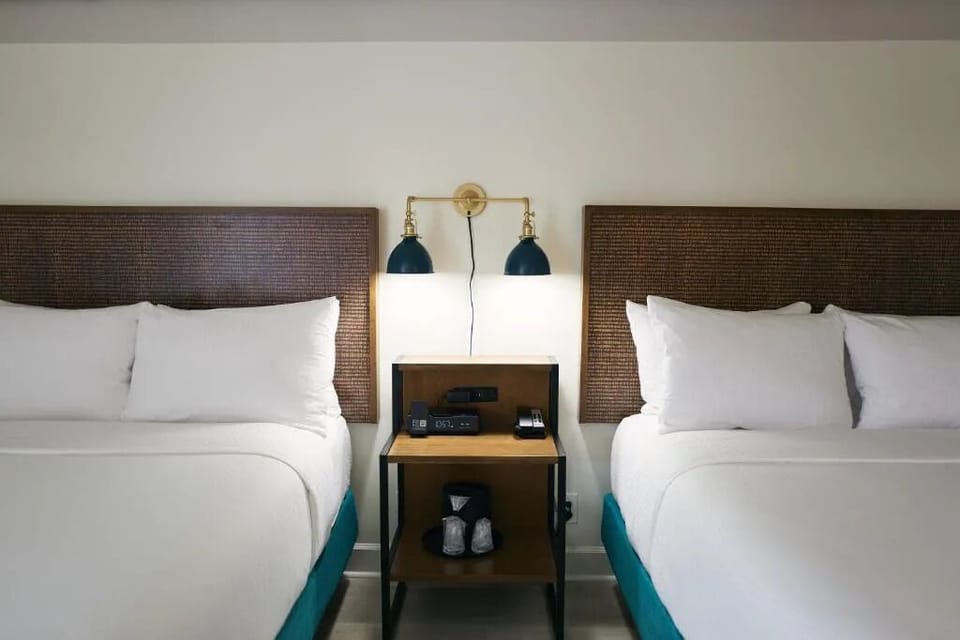 Settle into crisp linens with convenient bedside essentials.