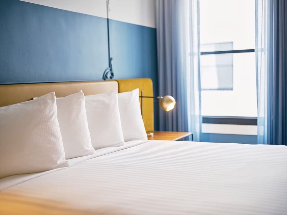 Stretch out on smooth, hotel-quality bedding in soft daylight.