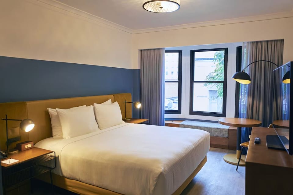 Relax in a spacious room framed by large, light-filled windows.