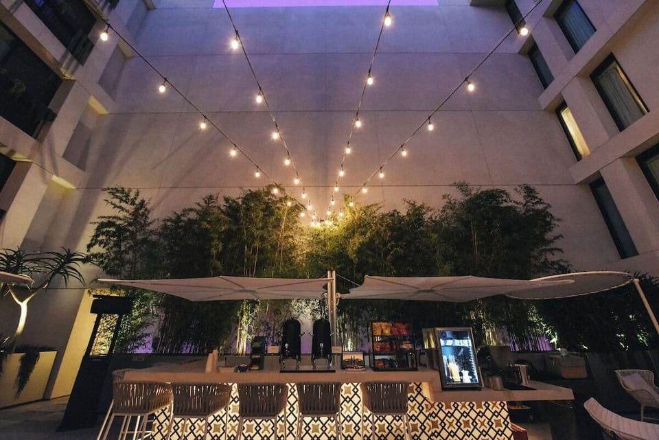 Gather under twinkling lights for a relaxed evening drink.