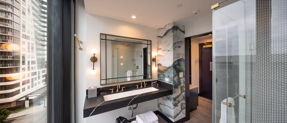 Refresh each morning with luxe marble vanity and brass fixtures.