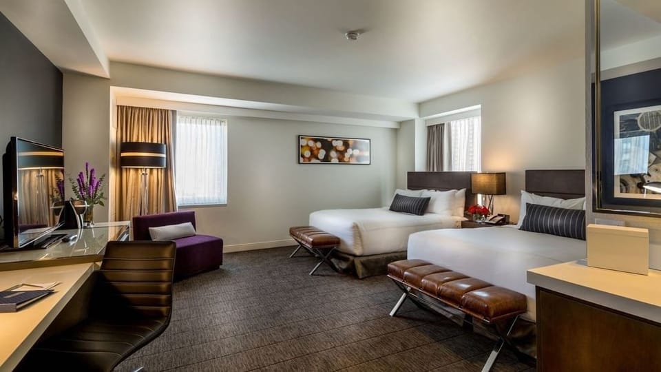 Settle in together with two plush beds and soft lighting.