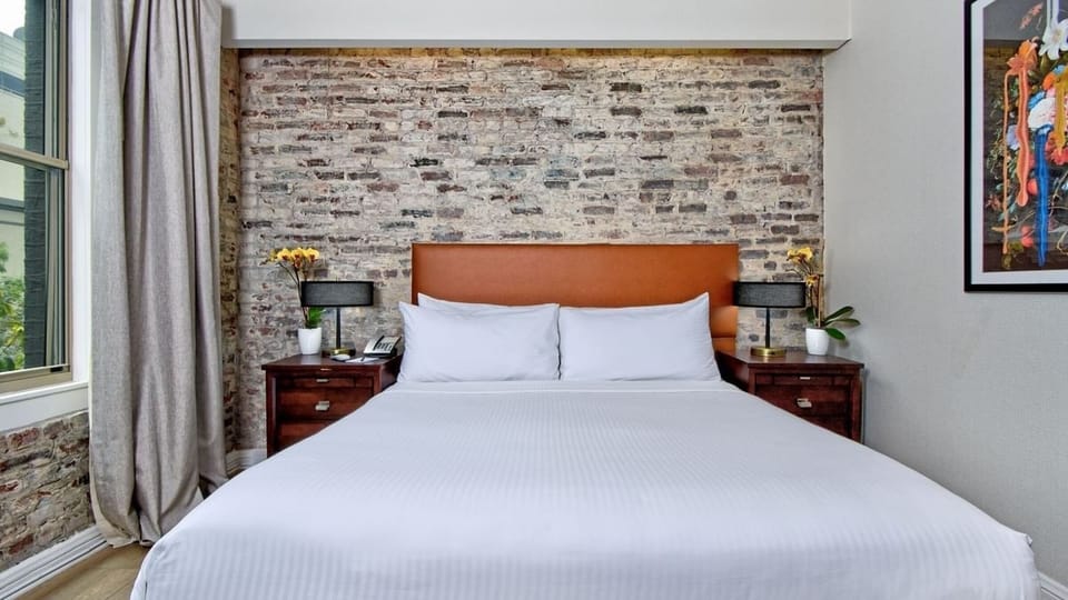 Stretch out in a serene king bed beneath exposed brick charm.