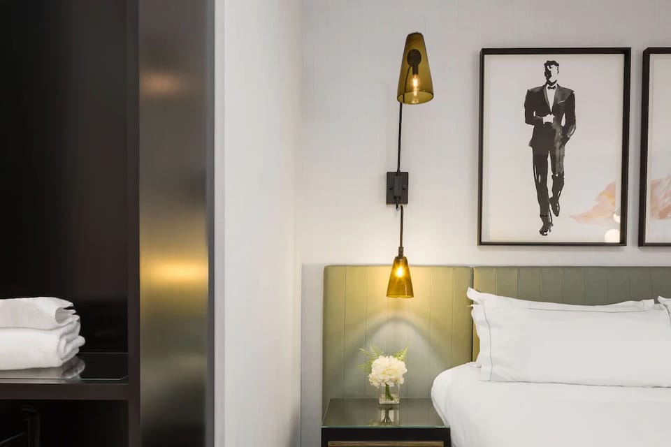 Unwind in crisp linens under warm, boutique-style lighting.