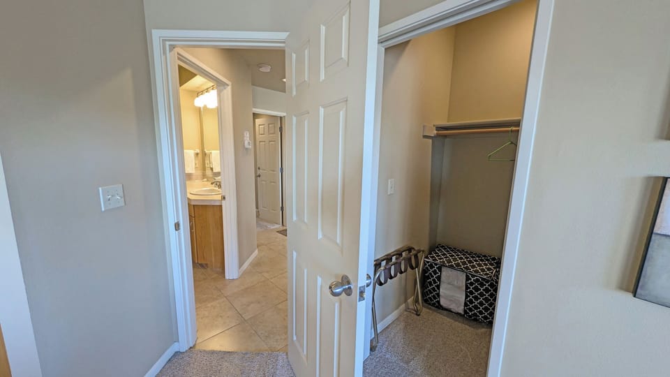 The walk-in closet and door to the hall
