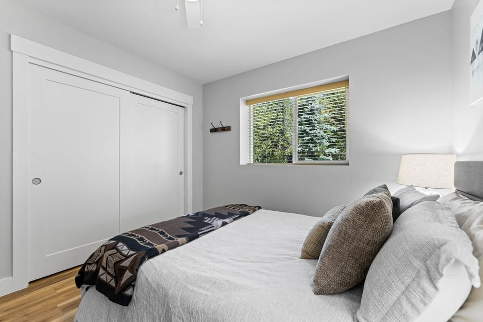 Bedroom #3 with a queen bed & a desk with a chair- single-level home