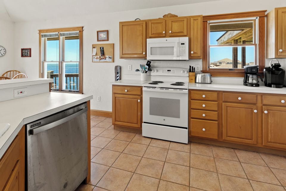 The fully-equipped Kitchen offers panoramic sound views that make even meal prep feel like part of the vacation.