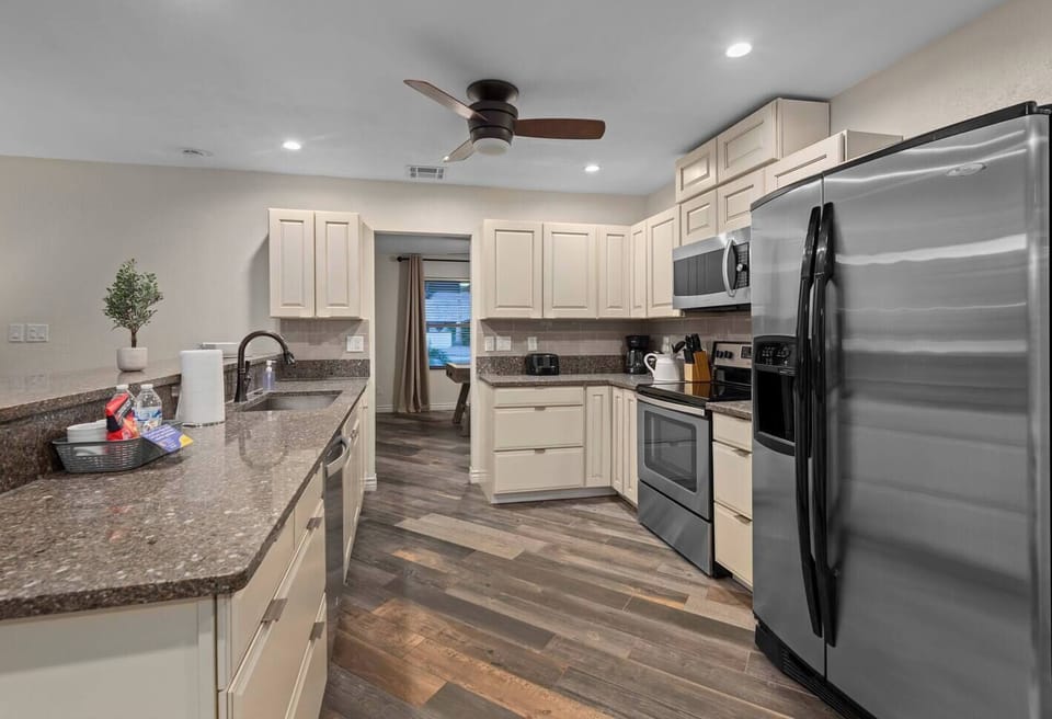 Large kitchen with size appliances and granite countertops.