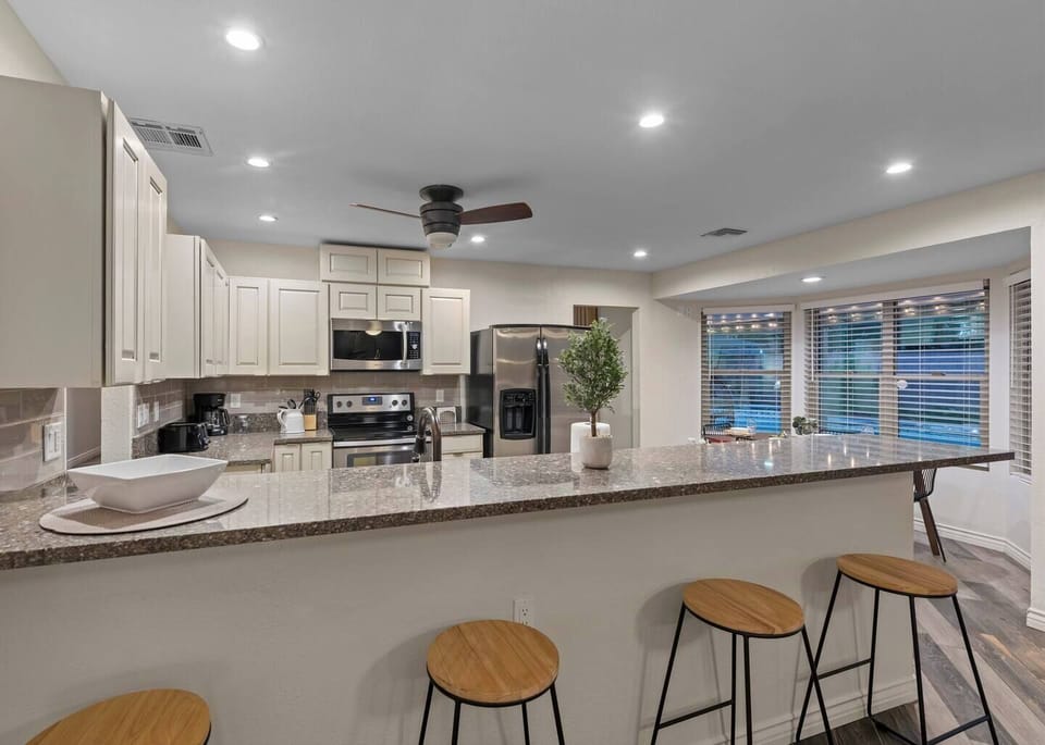 Large Open kitchen with granite countertops and full size appliances.