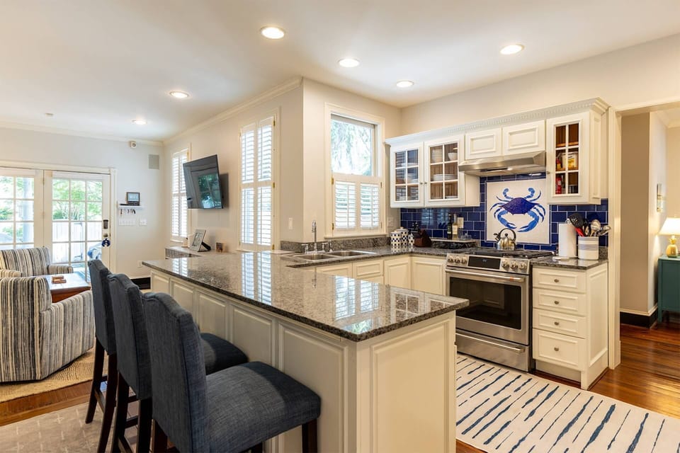 The home's open family room and kitchen are one of many gathering places in the home.